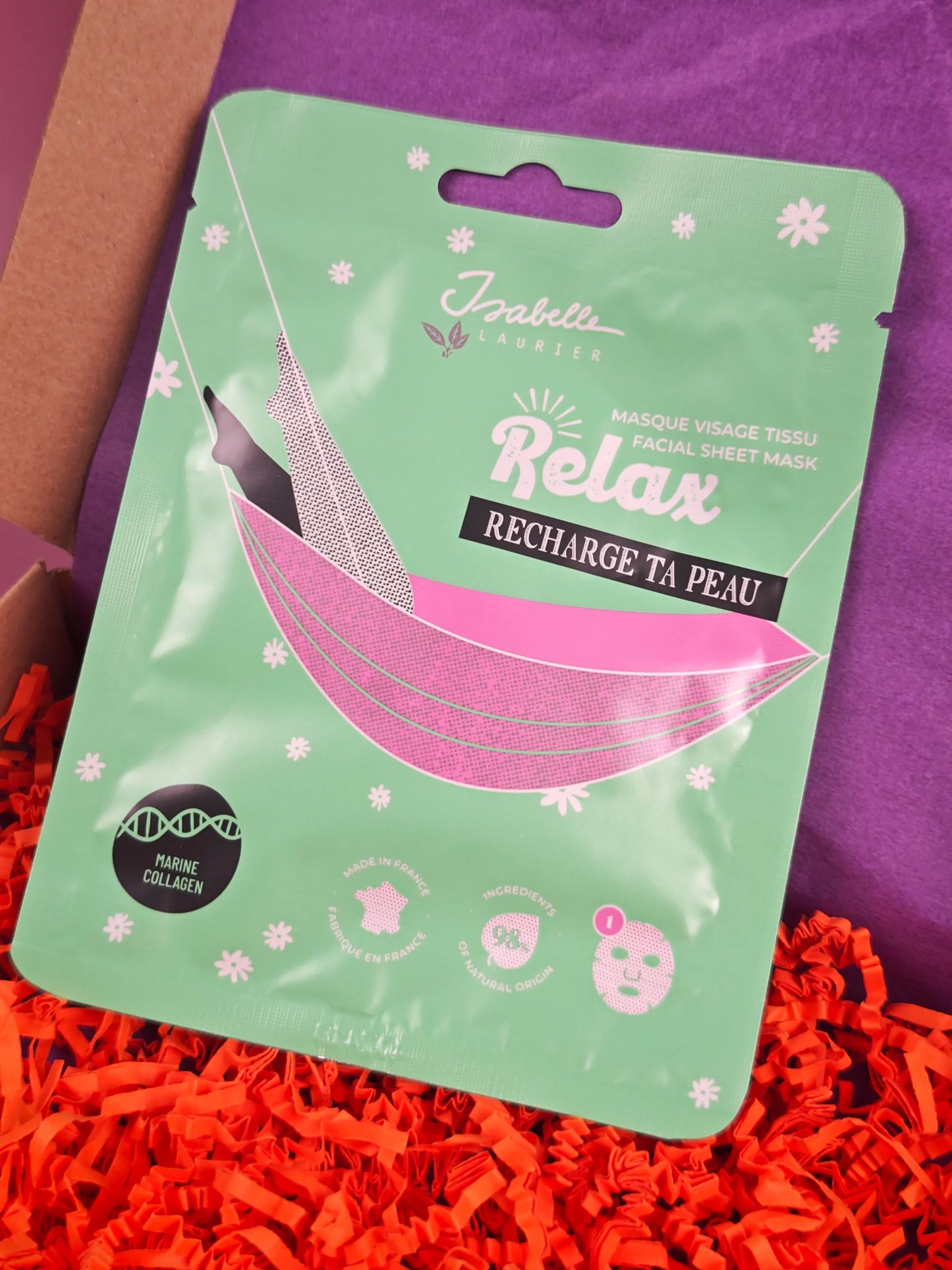 Isabelle Laurier gezichtsmasker, groene verpakking, op paarse en oranje geschenkverpakking.